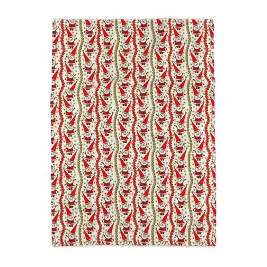 Luxe tea towel with repeating Santa face pattern in red and green on cream