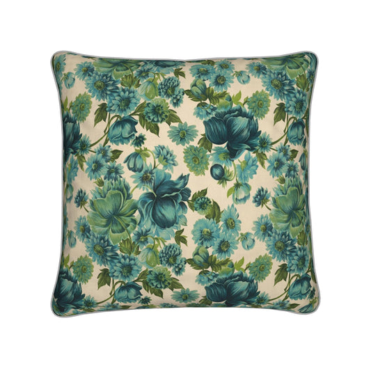Floral pillow with blue and green flowers on a cream background, framed by dark piping