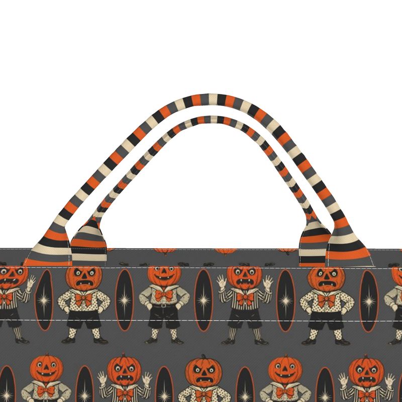 Everyday luxe tote close-up: striped handles and orange/black character pattern top panel