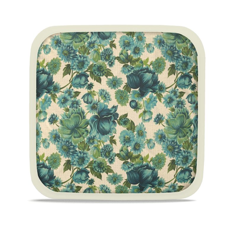 Floral hot dish pad with blue-green leaves on cream fabric, cream border
