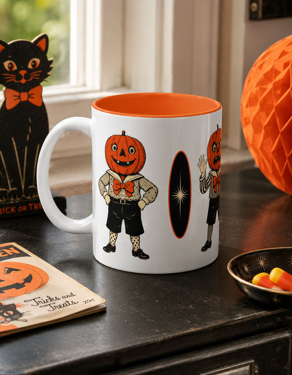 Vintage Halloween coffee mug with orange interior and jack-o-lantern character, on countertop