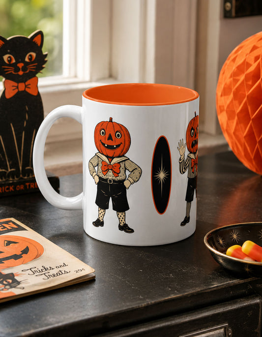 Vintage Halloween coffee mug with orange interior and jack-o-lantern character, on countertop