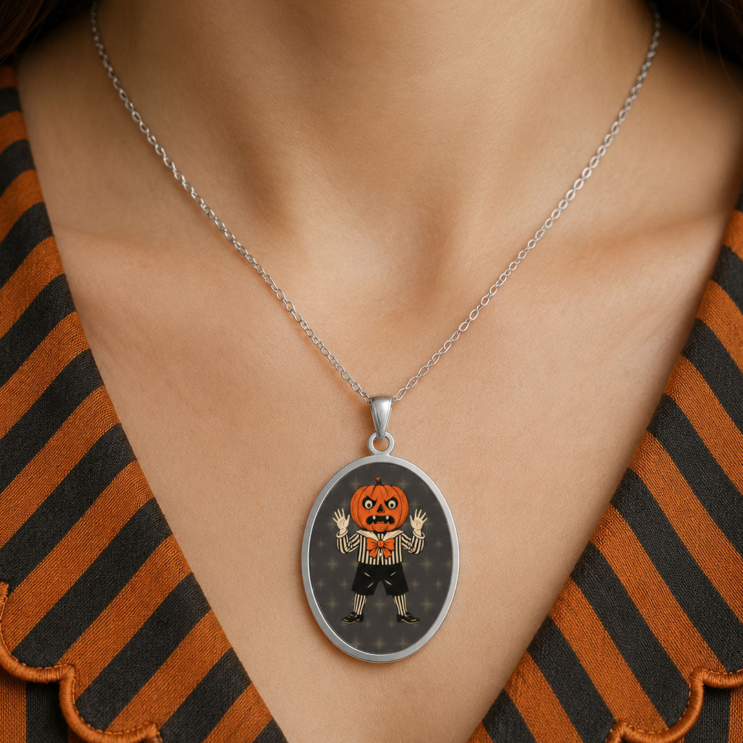 Jolly Jack oval pendant necklace on a silver chain, orange jack in black outfit