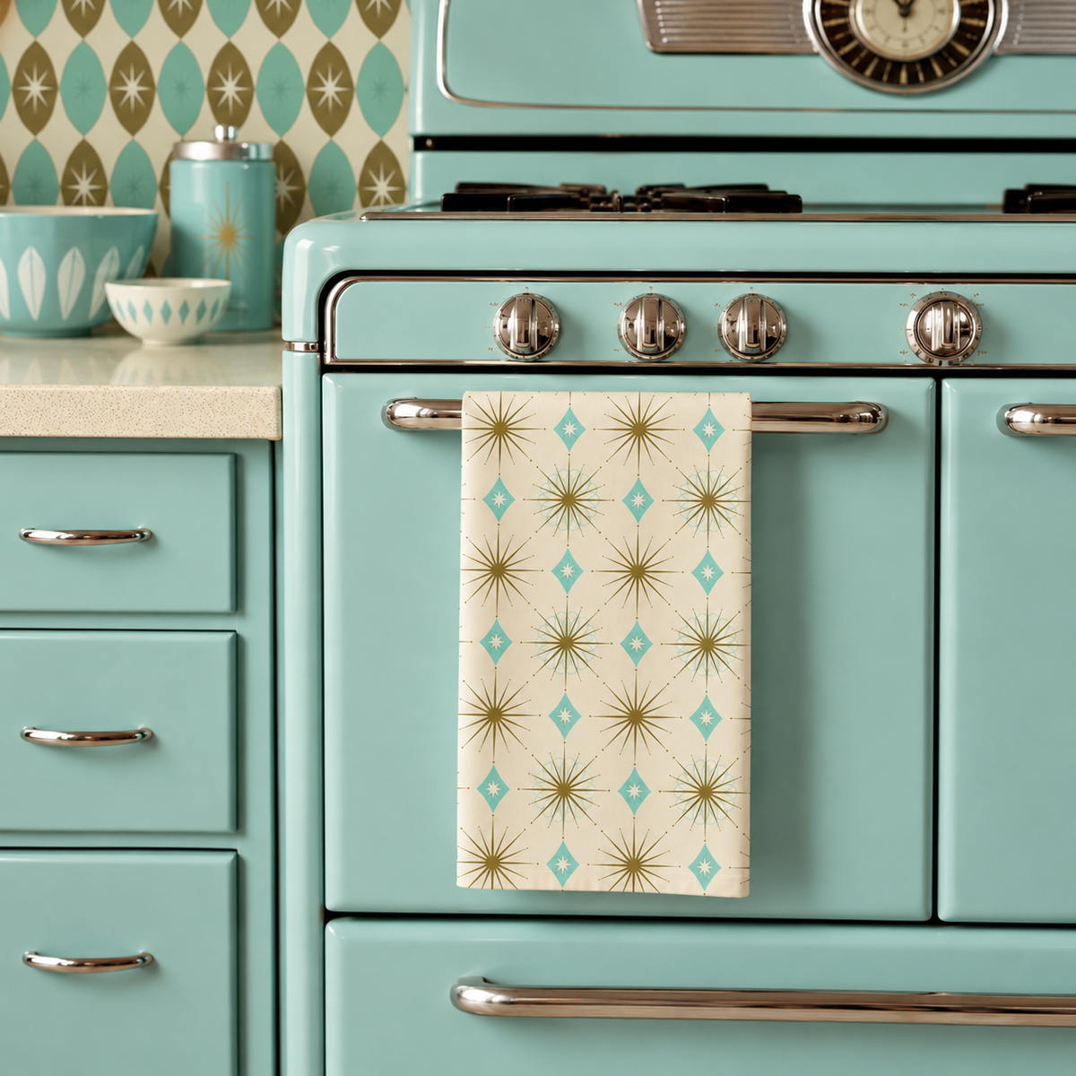 Kitchen towel with starburst pattern hanging on oven handle