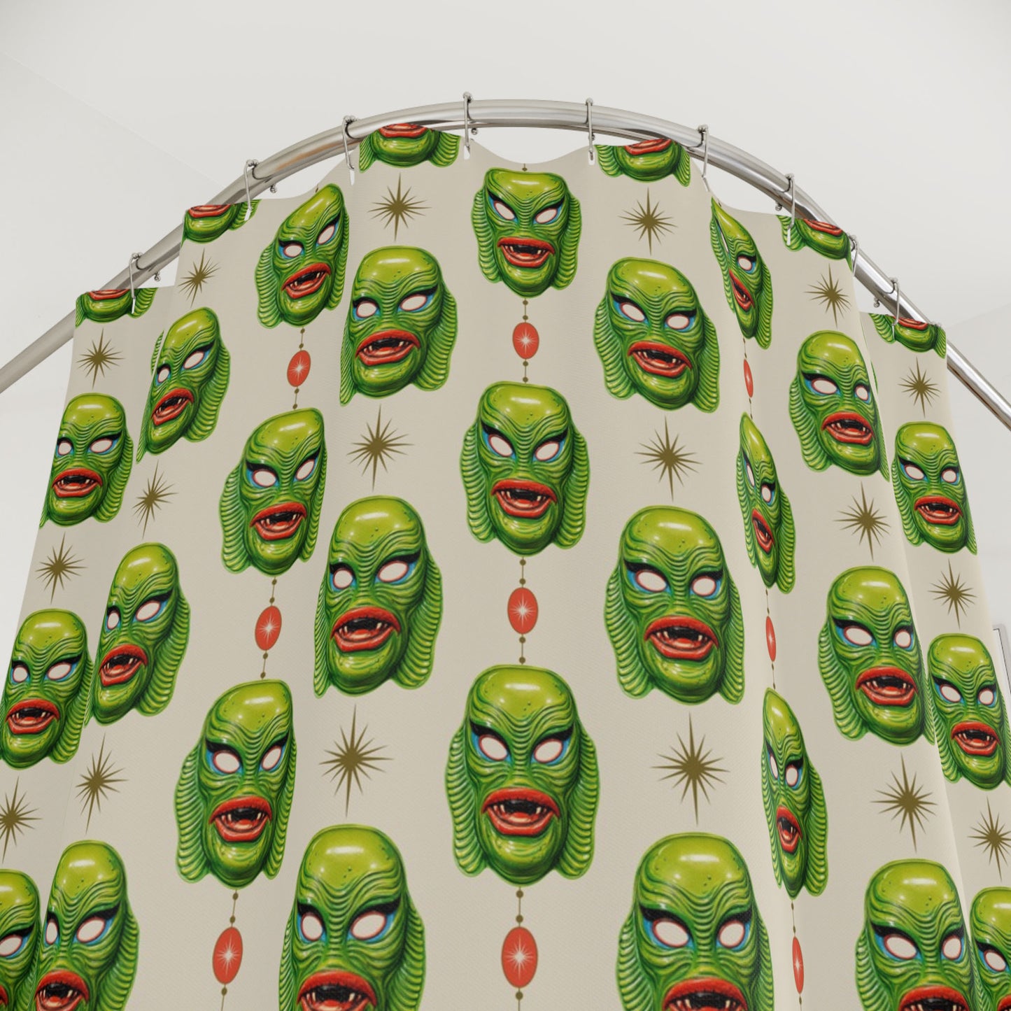 Halloween shower curtain with repeating green swamp creature faces and red hanging charms