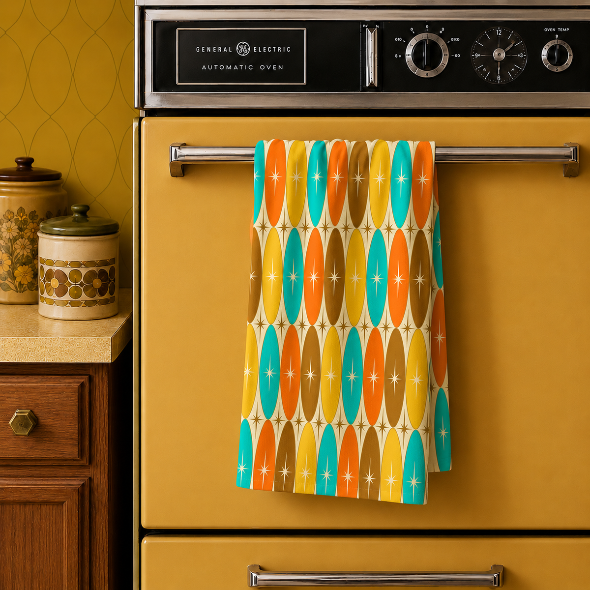 Hanging kitchen towel with retro geometric pattern in teal, orange, yellow, and brown