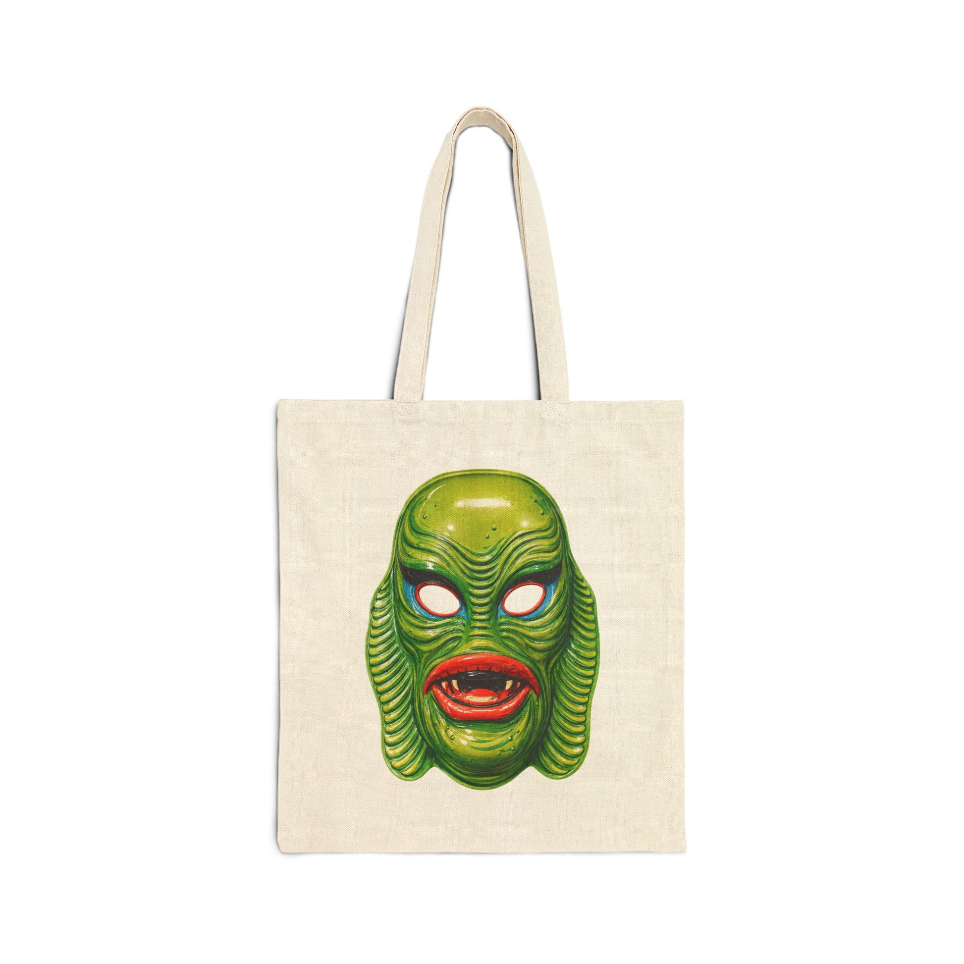 Tote bag with a vintage green swamp creature mask design on a white background