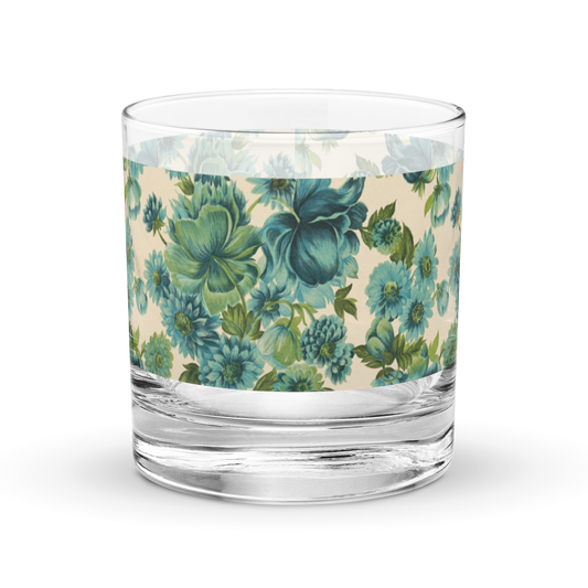Rocks glass with teal and blue floral wrap design on clear glass