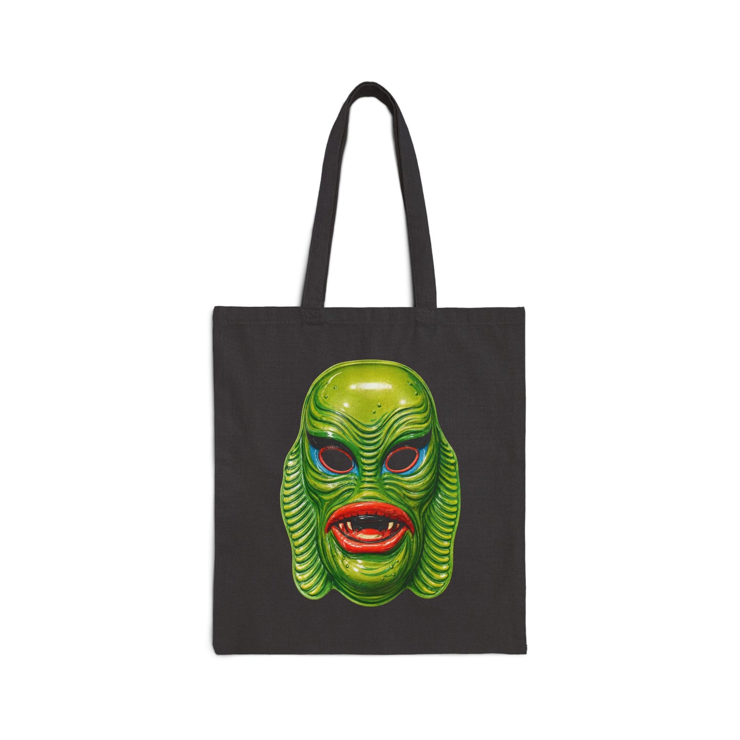 Black tote bag with a swamp creature green mask design on a white background